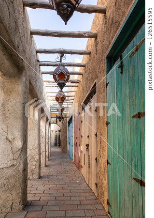 Old town in Al Seef Cultural Historical District on shores of Dubai Creek. Tourist place with old streets, houses and shops, Dubai, UAE. Vertical photo 126515595