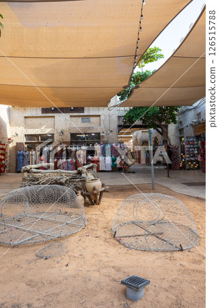 Old town in Al Seef Cultural Historical District on shores of Dubai Creek. Tourist place with old streets, houses and shops, Dubai, UAE. Vertical photo Old town in Al Seef Cultural Historical District on shores of Dubai Creek. Tourist place with old streets, houses and shops, Dubai, UAE. Vertical photo 126515788