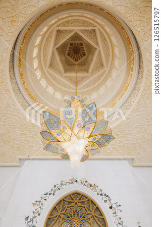 View of Sheikh Zayed Grand Mosque in Abu Dhabi made of white marble with flowers made of precious stones in design. Inside mosque. Vertical photo 126515797