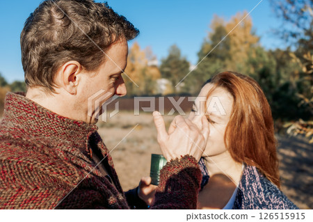 Happy beautiful couple in love enjoying autumn picnic in autumn park. Weekend and lifestyle concept. High quality photo Happy beautiful couple in love enjoying autumn picnic in autumn park. Weekend and lifestyle concept. High quality photo 126515915
