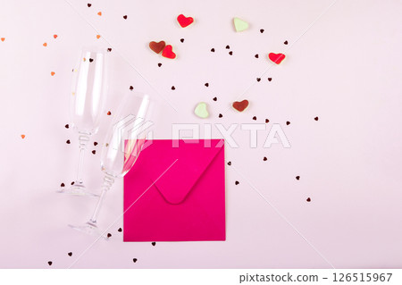 Word love, heart shaped sweets, confetti and glasses of champagne on white background. Valentine's day romantic party concept. Top view, flat lay, copy space 126515967