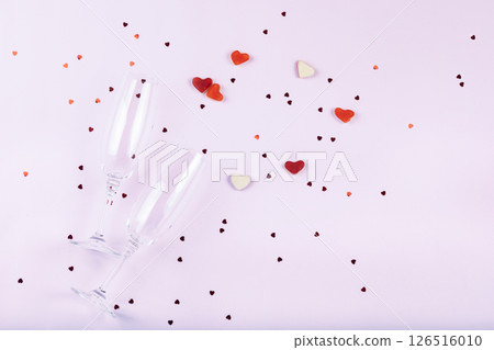 Word love, heart shaped sweets, confetti and glasses of champagne on white background. Valentine's day romantic party concept. Top view, flat lay, copy space 126516010