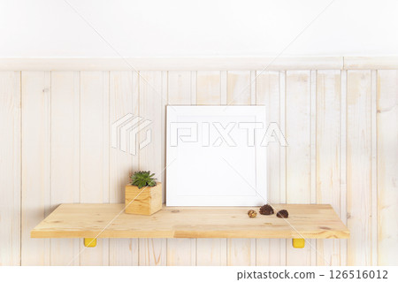 Mock up poster frame on wooden shelf with with succulent in Scandinavian style interior with wooden furnitures. Minimalist interior design 126516012