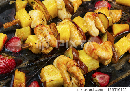 Chicken meat with pineapple on skewers. Chicken meat with pineapple on skewers. 126516121