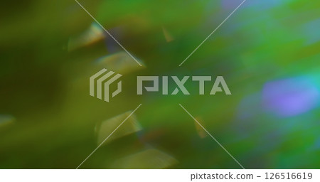Defocused light swirls. Flare circle. Abstract green purple color lens floating glow on blurred green luminous art background. Defocused light swirls. Flare circle. Abstract green purple color lens floating glow on blurred green luminous art background. 126516619