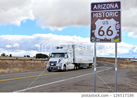 A semi-trailer truck passes by the Route 66 sign just before Seligman. 126517186