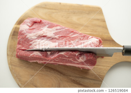 Cut beef into chunks 126519084