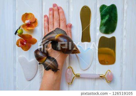 Two achatinas on hand and facial massage kit made from natural stones and metal 126519105
