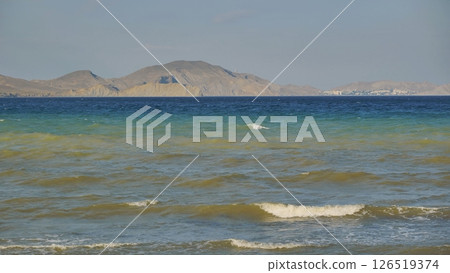 Gentle waves washing Crimean coast on a sunny day 126519374