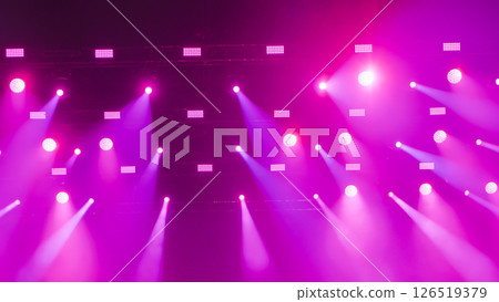 Purple stage lights illuminating the darkness creating a vibrant spectacle 126519379