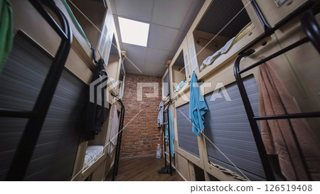 Compact hostel sleeping pods providing privacy and comfort for budget travelers 126519408