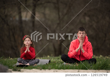 Mindful moments in green nature where children practice deep meditation and mindfulness on a peaceful day surrounded by tranquility and relaxation 126519749