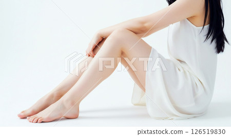 Side angle image of a beautiful fair-skinned woman sitting with her healthy legs bent 126519830