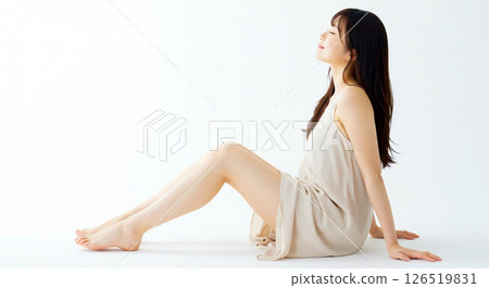 Side angle image of a beautiful fair-skinned woman sitting with her healthy legs bent Side angle image of a beautiful fair-skinned woman sitting with her healthy legs bent 126519831