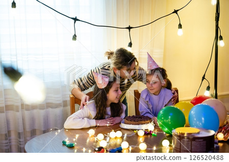 Celebrating friendship with joy and laughter during a cozy birthday party at home with delightful desserts and colorful decorations Celebrating friendship with joy and laughter during a cozy birthday party at home with delightful desserts and colorful decorations 126520488