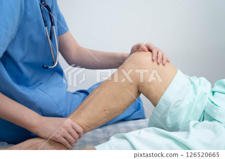 Doctor checking Asian elderly woman patient with scar knee replacement surgery in hospital. Doctor checking Asian elderly woman patient with scar knee replacement surgery in hospital. 126520665