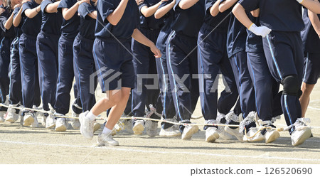 People participating in a centipede race at a sports festival People participating in a centipede race at a sports festival 126520690