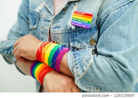 Asian woman with rainbow flag, LGBT symbol rights and gender equality, LGBT Pride Month in June. Asian woman with rainbow flag, LGBT symbol rights and gender equality, LGBT Pride Month in June. 126520697
