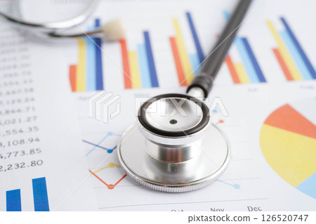 Stethoscope on chart or graph paper, Financial, account, statistics and business data medical health. Stethoscope on chart or graph paper, Financial, account, statistics and business data medical health. 126520747