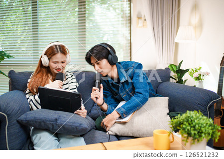 Online podcast planning with young man and woman using tablet and microphones 126521232