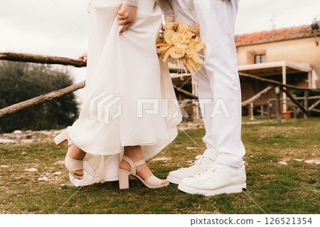 Bride and Groom's Feet with Bouquet on Rustic Wedding Day Bride and Groom's Feet with Bouquet on Rustic Wedding Day 126521354