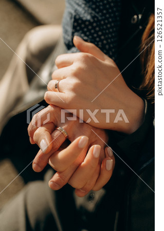 Close-Up of Tender Hands Holding with Rings 126521357