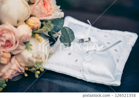 Elegant Wedding Rings on Pillow with Floral Decoration Elegant Wedding Rings on Pillow with Floral Decoration 126521358