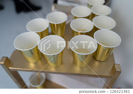 Golden Cups Ready for a Celebration on Cart 126521361