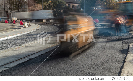 Asphalt roller and excavator on the road repair site during asphalting timelapse. Road construction equipment. Asphalt roller and excavator on the road repair site during asphalting timelapse. Road construction equipment. 126521903