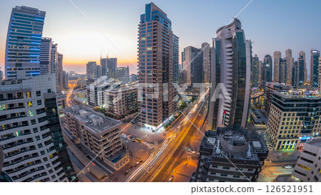 Aerial view of Dubai Marina after sunset from a vantage point day to night timelapse. Aerial view of Dubai Marina after sunset from a vantage point day to night timelapse. 126521951