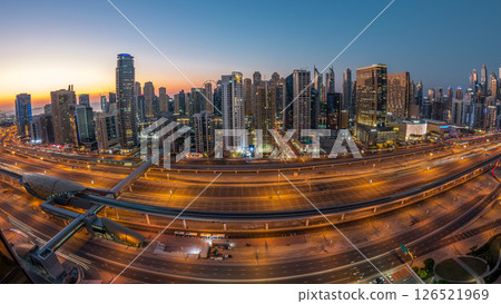 Dubai marina with traffic on sheikh zayed road panorama day to night timelapse lights turn on. 126521969