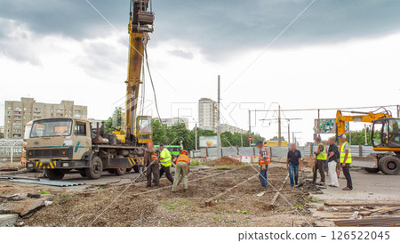 Demolition of old tram rails by crane at road construction site timelapse. 126522045