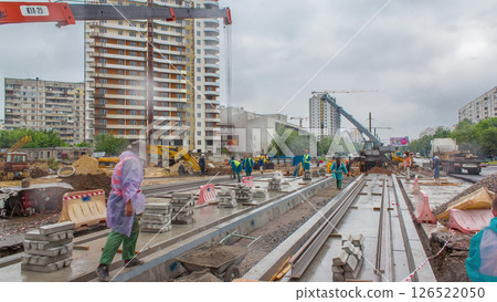 Gray construction telescopic crane unloading tram rails from truck timelapse. Gray construction telescopic crane unloading tram rails from truck timelapse. 126522050
