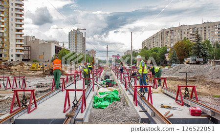 Tram rails at the stage of their installation and integration into concrete plates on the road timelapse. 126522051