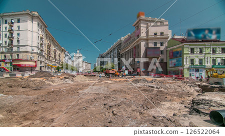 Excavator working on earthmoving at open pit mining in the city street timelapse. 126522064