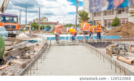 Concrete works for road construction with many workers and concrete pump timelapse 126522068