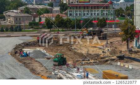 Excavator working on earthmoving at open pit mining in the city street timelapse. 126522077