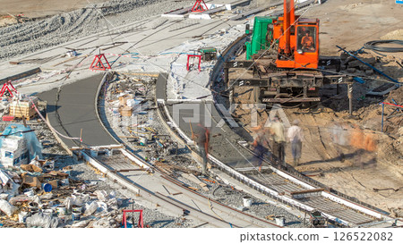 Concrete works for road construction with many workers and mixer timelapse 126522082