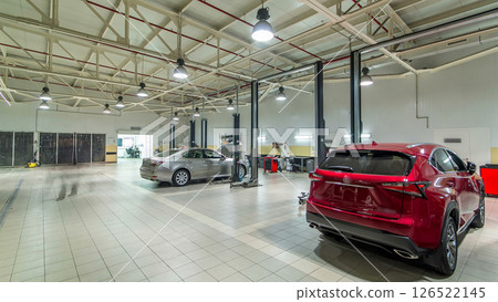 Cars moves on lifts in modern service station and men repair cars timelapse hyperlapse. 126522145