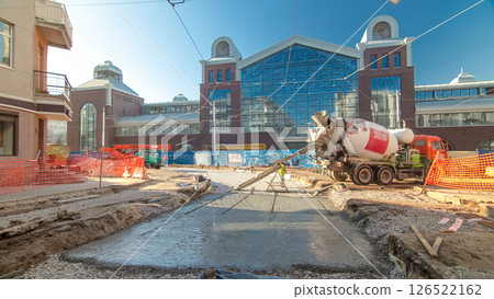 Concrete works for road maintenance construction site with many workers and mixer timelapse 126522162