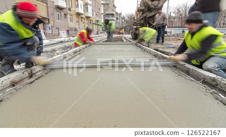 Pouring ready-mixed concrete after placing steel reinforcement to make the road by concrete mixer timelapse hyperlapse. Pouring ready-mixed concrete after placing steel reinforcement to make the road by concrete mixer timelapse hyperlapse. 126522167