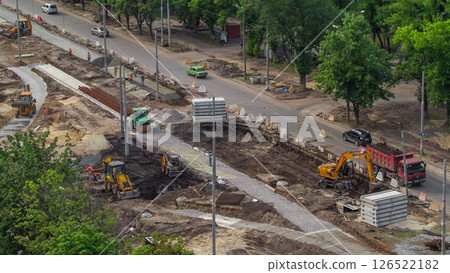 Industrial truck loader excavator moving earth and loading into a dumper truck timelapse 126522182