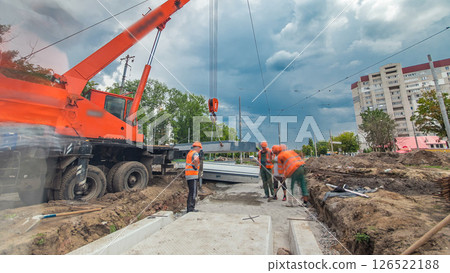 Installing concrete plates by crane at road construction site timelapse hyperlapse. 126522188