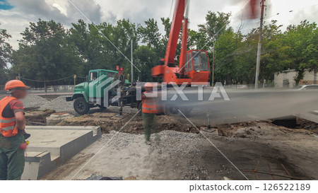 Installing concrete plates by crane at road construction site timelapse hyperlapse. Installing concrete plates by crane at road construction site timelapse hyperlapse. 126522189