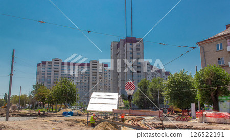 Yellow construction telescopic crane moving tram rails timelapse. Yellow construction telescopic crane moving tram rails timelapse. 126522191