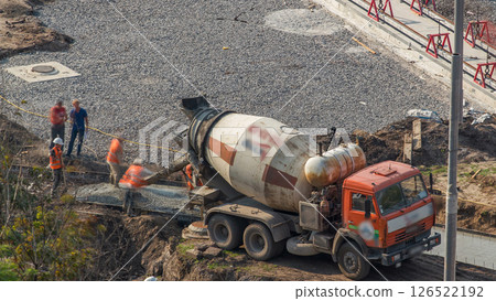 Mixer machine at concrete works for road construction with many workers timelapse Mixer machine at concrete works for road construction with many workers timelapse 126522192