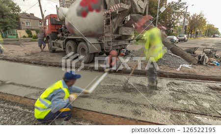 Concrete works for road construction with many workers and mixer timelapse hyperlapse 126522195