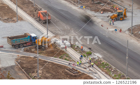 Industrial truck loader excavator moving ground and loading into a dumper truck timelapse 126522196