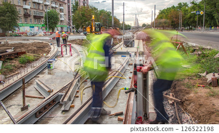 Workers install new tram rails during a reconstruction of the route timelapse. Workers install new tram rails during a reconstruction of the route timelapse. 126522198