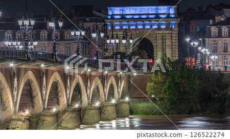 Pont de Pierre stone bridge with Porte de Bourgogne night timelapse in Bordeaux, France. 126522274